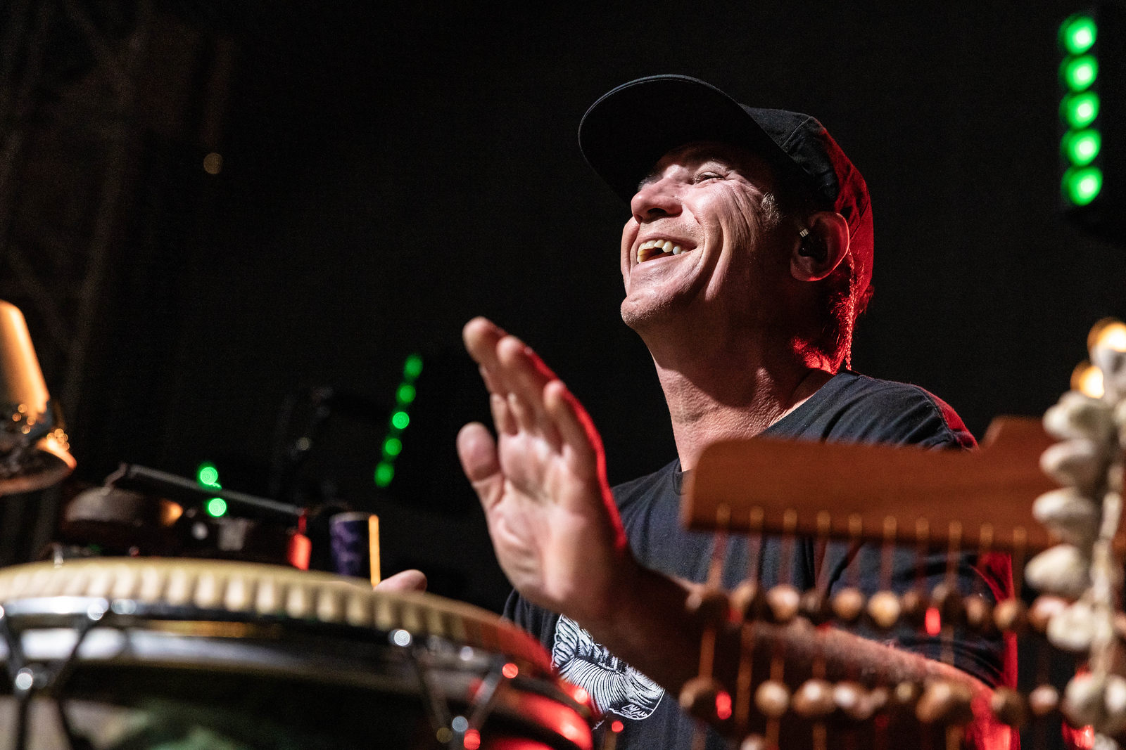 Will Phillips smiling while performing percussion live